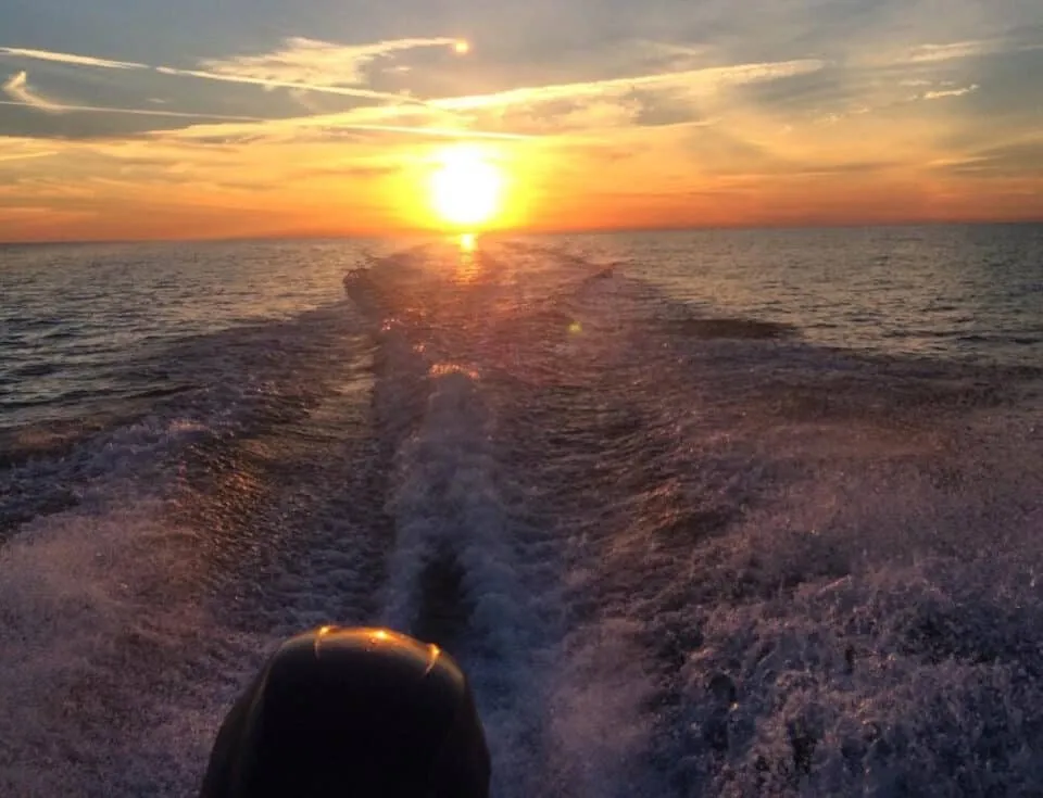 Sunset cruises on AMI from the rear of speeding boat