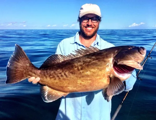 Offshore Charters in February man holding a monster gag grouper