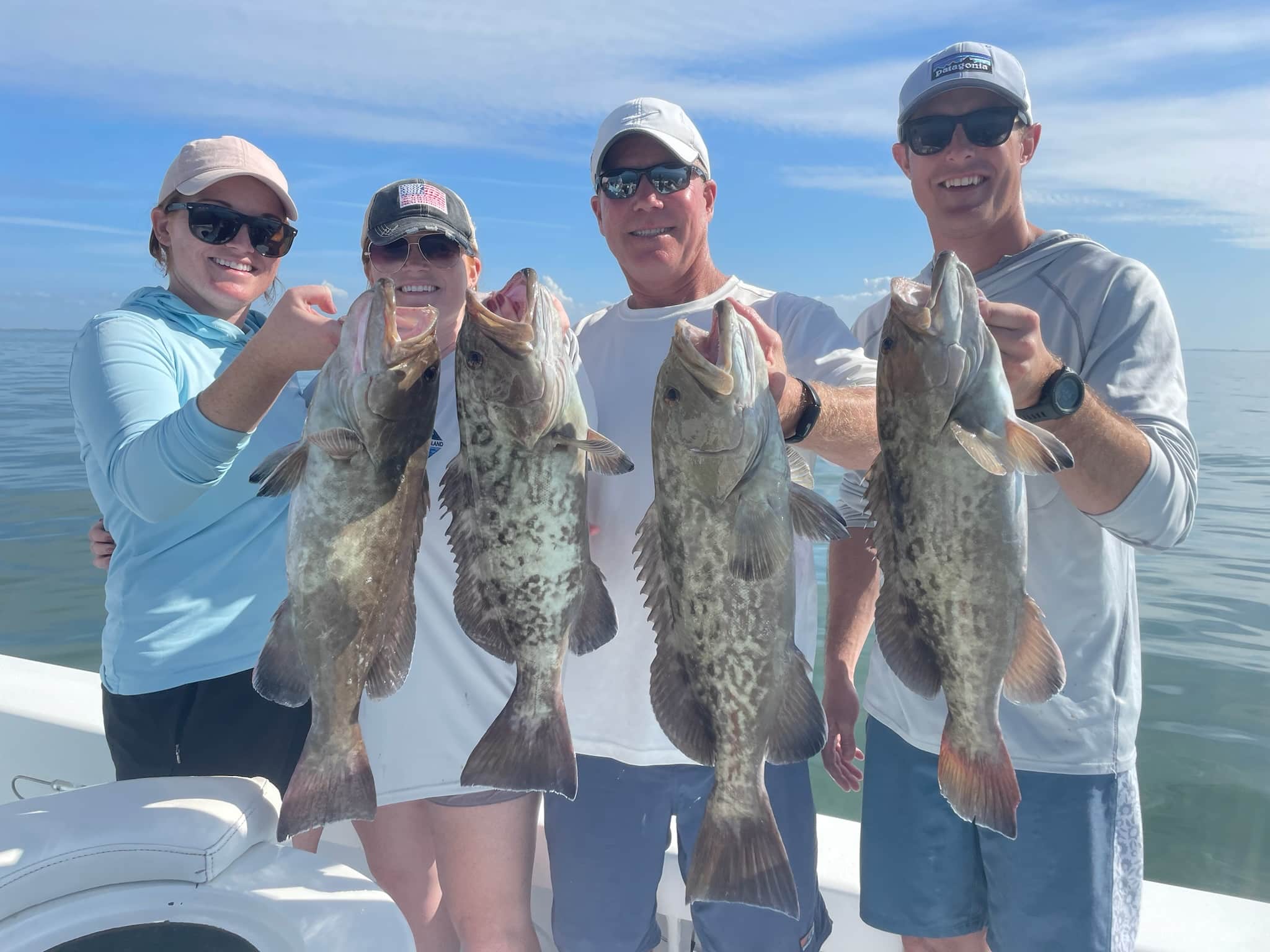 Offshore Charters in February 4 fisherman holding gag groupers