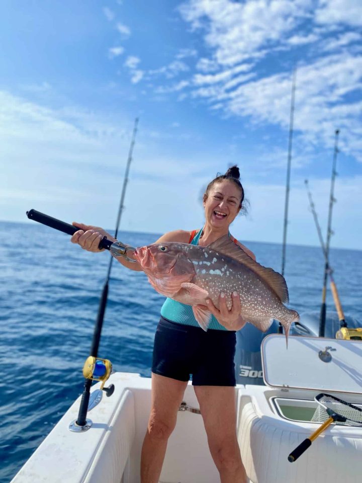 Anna Maria Offshore Charters-the Best in SW Florida Girl holding a red grouper with a gag