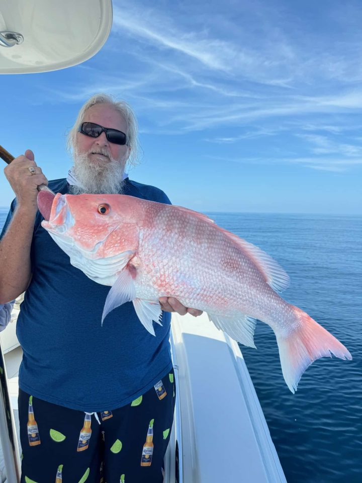 red snapper fishing charters man holding red snapper